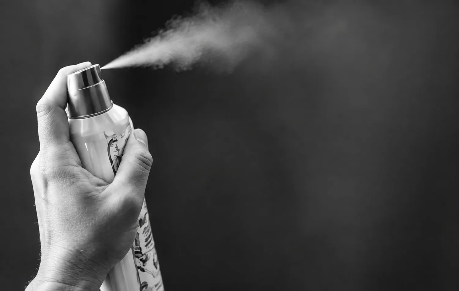 Hand spraying a conventional aerosol air freshener